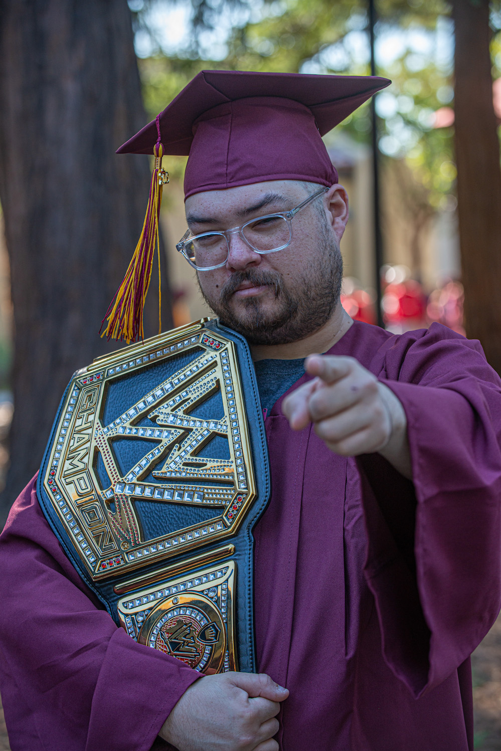grad with champion belt