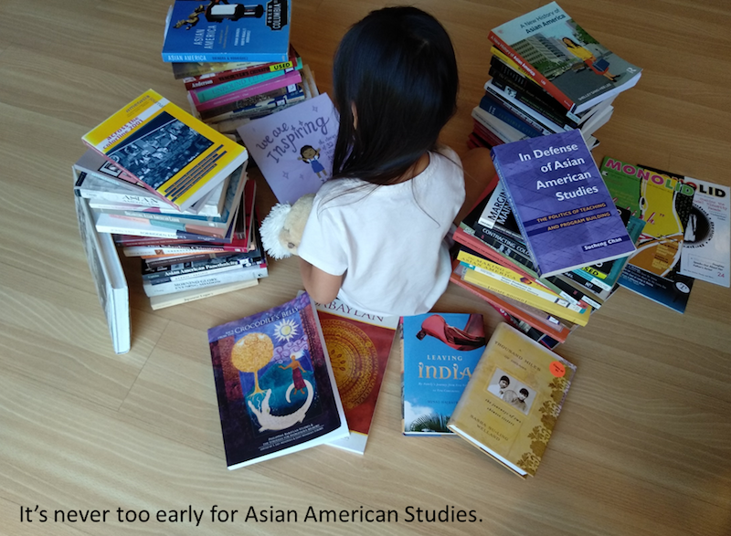 child surrounded by books: It's never too early for Asian American Studies