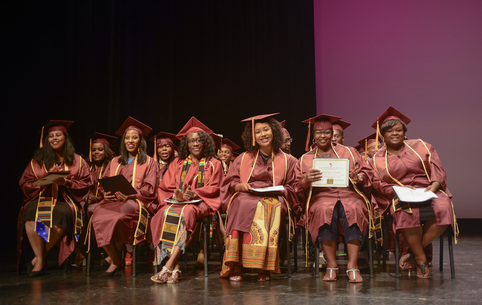 seated graduates at black grad achievement ceremony