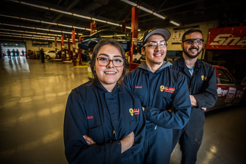 three auto tech students with arms crossed