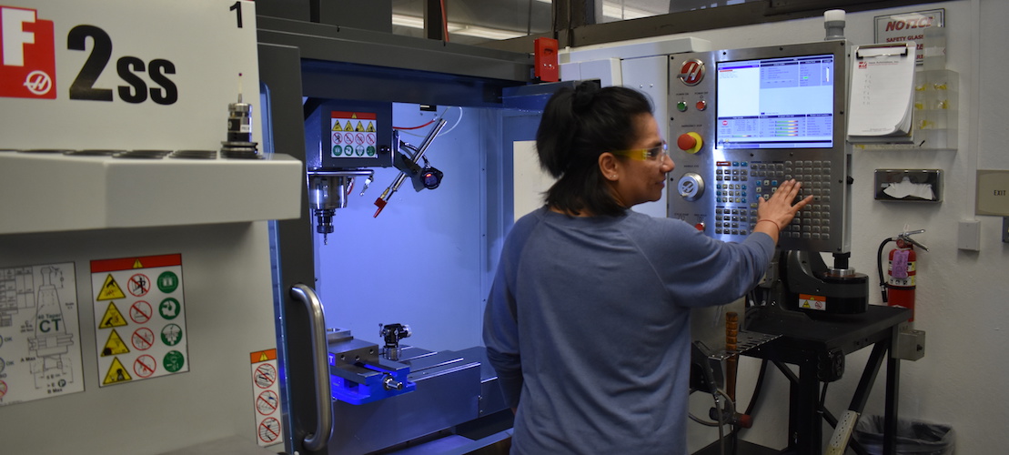 young woman student at Haas machine