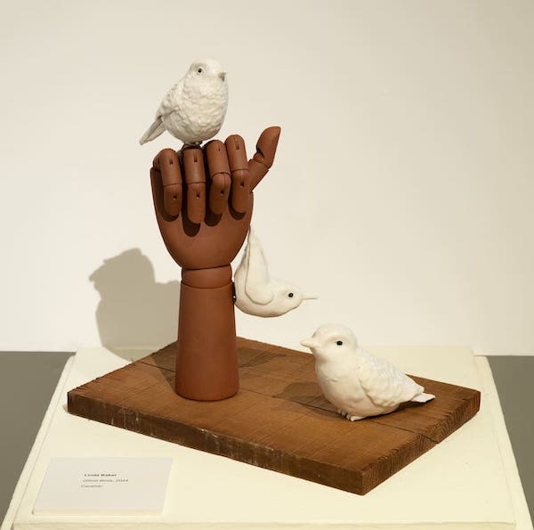 sculpture of hand and birds