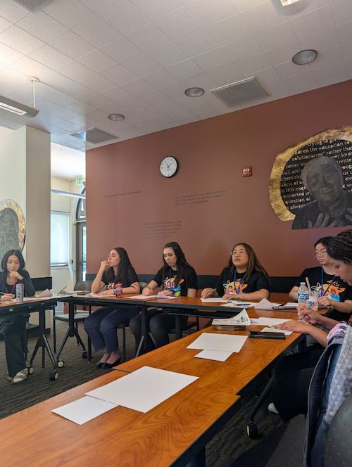 students at conference table