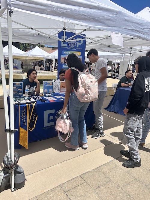 students talking at information table