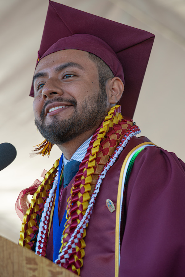 young man in grad cap at podium