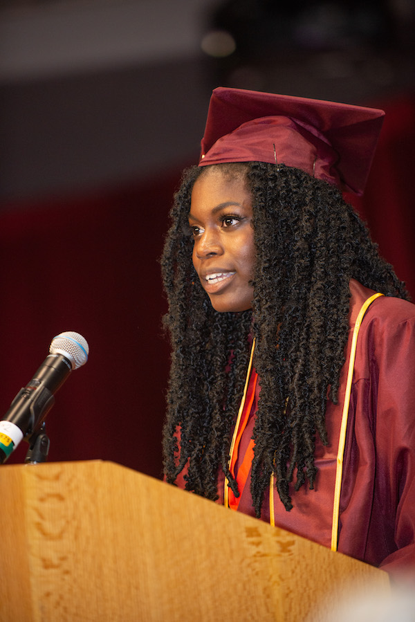 smiling female grad at podium 