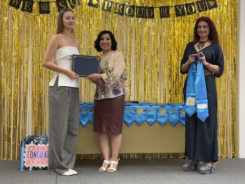 student on stage with counselors