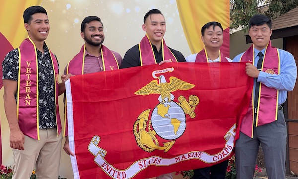 five veteran grads with USMC banner